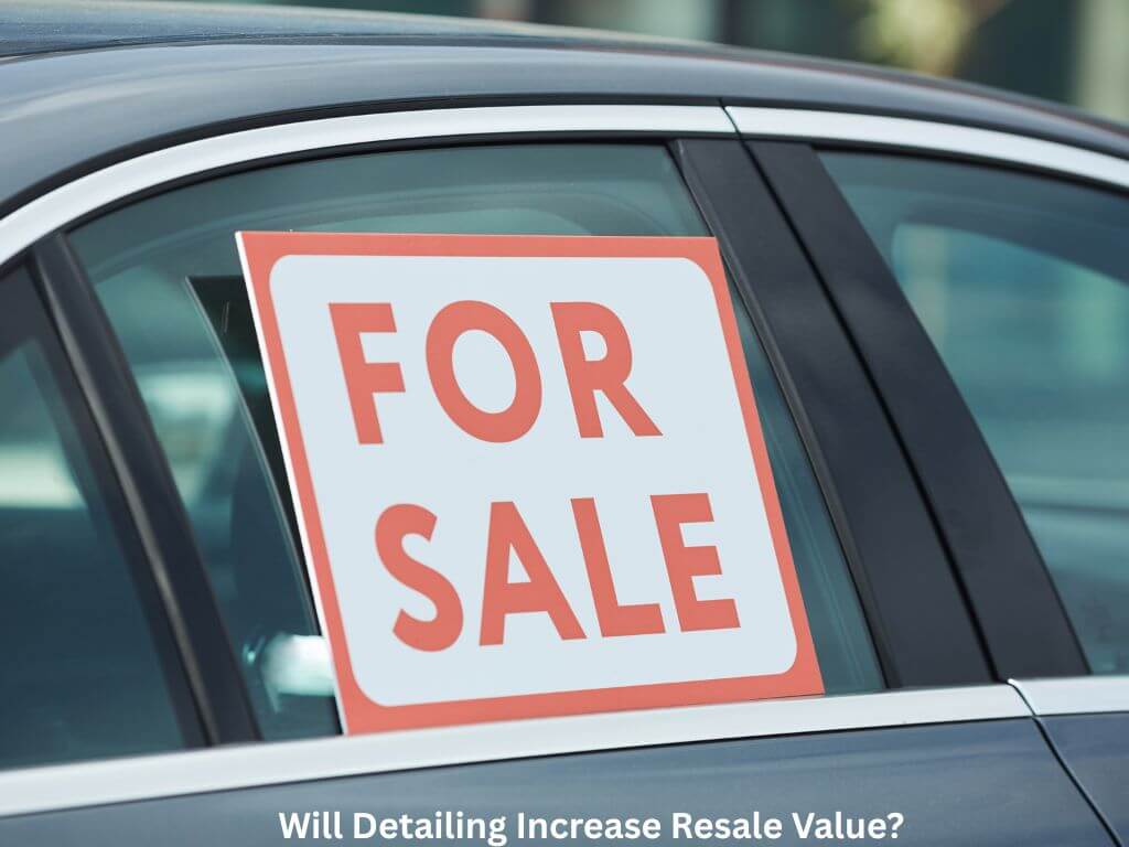 Car with a for sale sign in it.